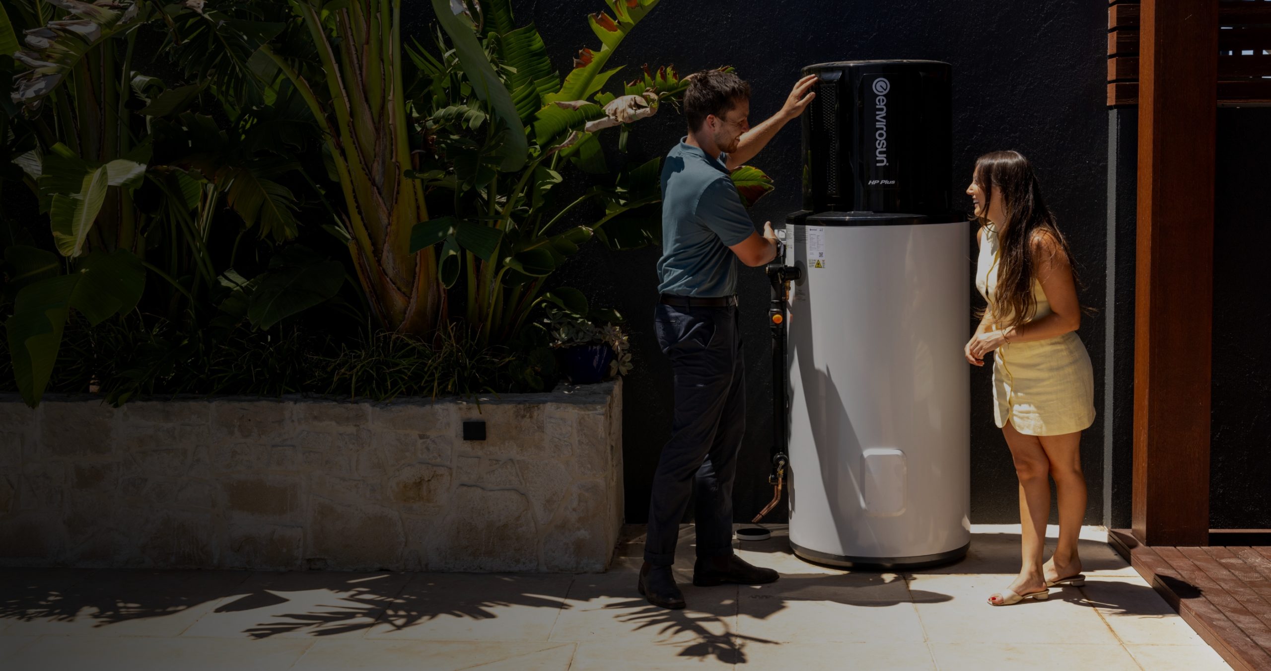 A technician commissioning a heat pump hot water system